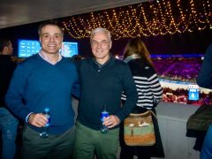 Two men standing next to each other at a sporting event