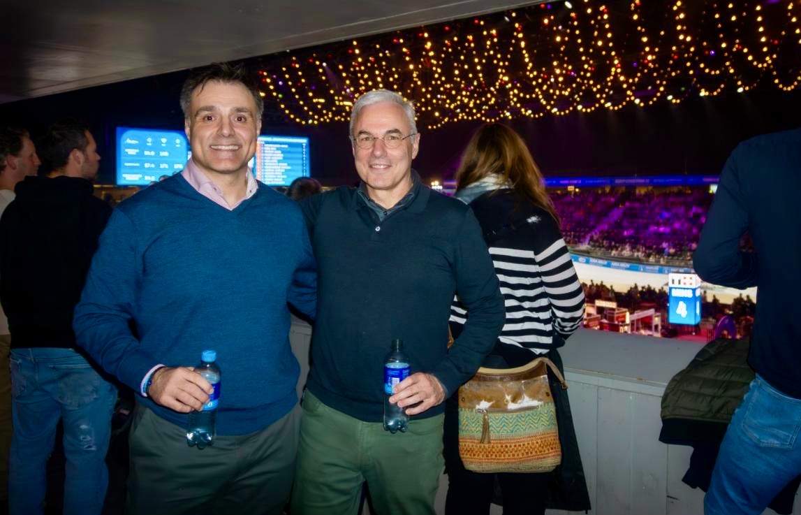 Two men standing next to each other at a sporting event